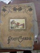 Victorian postcard album (dilapidated) containing a few postcards, silk postcards inc Bulldog,