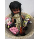 An Indian doll and 2 clwo dolls