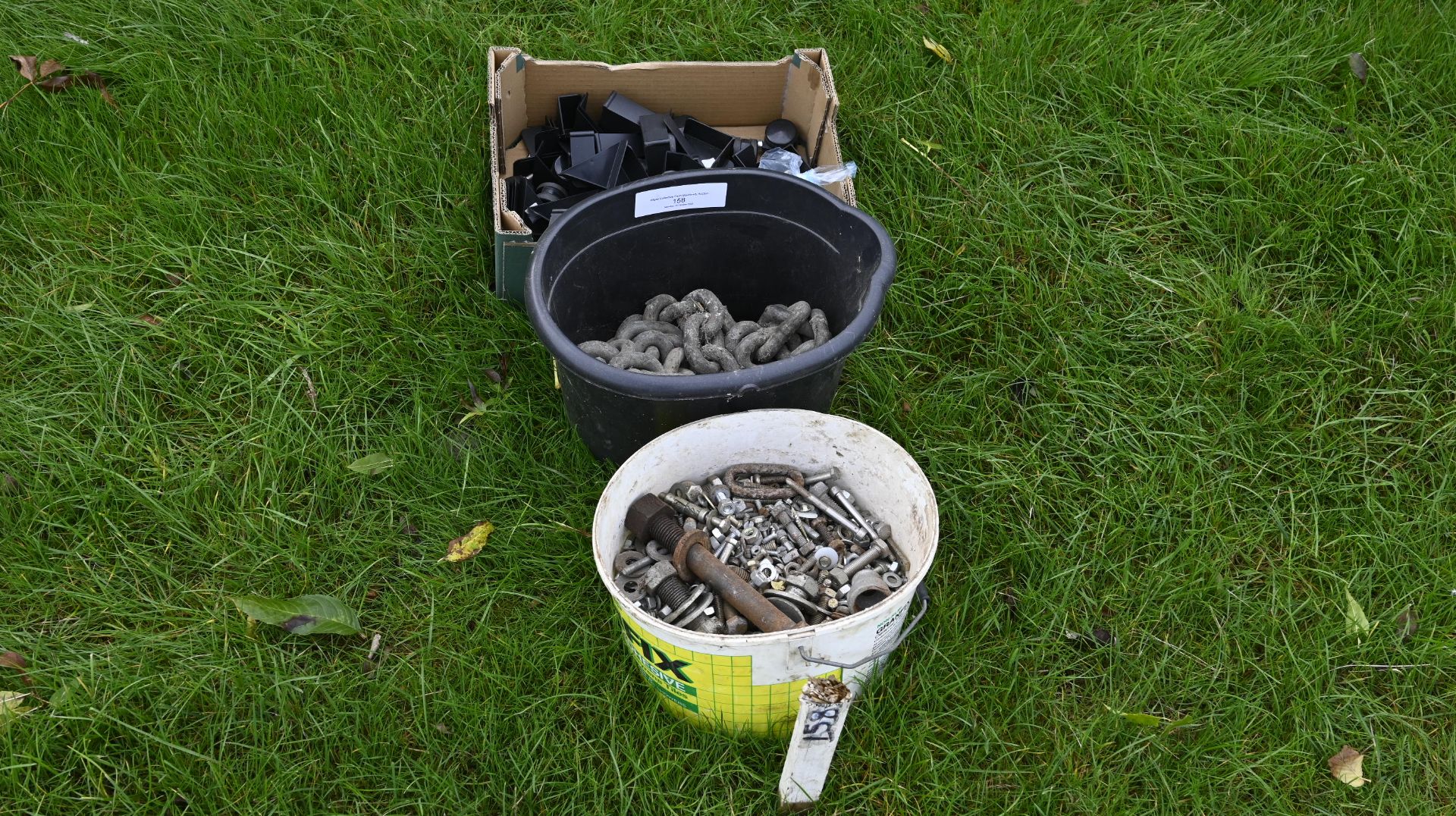 Tractor tow chain + bucket of assorted bolts