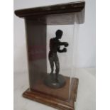 a figure of a boxer in glass case