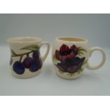 2 Moorcroft pottery mugs to incl 1985 mug featuring wood anemones on a cream background dated to
