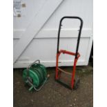 Sack barrow and hose pipe on reel