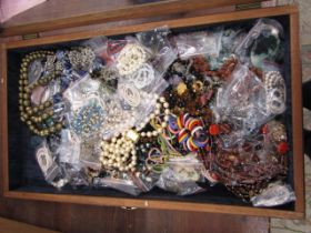 A display case full of costume jewellery and a bag of jewellery boxes