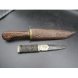 A  carved Indian dagger and one with a thistle design on case