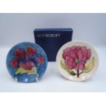 2 Moorcroft Pottery Pin Trays, one painted in the 'Hibiscus' (red) pattern on a shaded blue/green