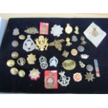 A collection of cap badges and buttons