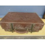 A vintage leather suitcase stamped S.R.M with rising hinges