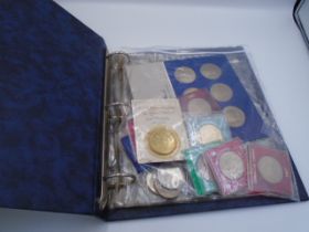 About 30 modern Crowns - including some £2 and medallions in a blue folder