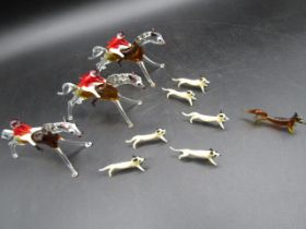 A Murano style coloured glass hunting set comprising of 3 horses and riders, 6 dogs and a fox.  1