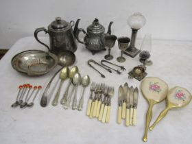 Various metal wares and cutlery plus a vanity mirror and brush set