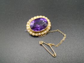 15 ct gold Victorian era, amethyst and seed pearl oval brooch, with safety chain 5.91g gross