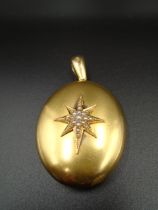 18ct gold Victorian hallmarked oval locket with seed pearl North Star design on front and monogram