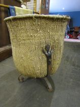 A weaved vintage log basket on cast iron feet with a liner in a medieval/Saxon style the basket is