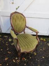 Upholstered balloon back armchair with brass castors