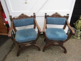 Pair of carved oak Savonarola chairs with upholstered seats and backs