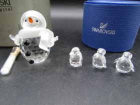 A Swarovski Snowman (6cmH) and 3 small penguins, all boxed with certs