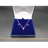 A boxed 18ct gold and diamond necklace, with 9ct gold and diamond earrings, (butterfly backs are