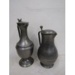 2 large, heavy pewter jugs with fleur d' lys emblem tallest 37cm