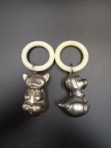 2 silver plated baby rattles with teething rings in the shape of a dog and koala bear
