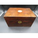 A wooden sewing box with brass escutcheon and inlay