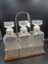 Silver plated tantalus with 3 cut glass decanters