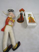 A tin wind up doll and Material Sonny Jim doll