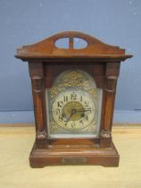 Oak cased mantel clock with key (top piece needs reattaching)