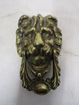 A brass lion face door knocker 20cmL