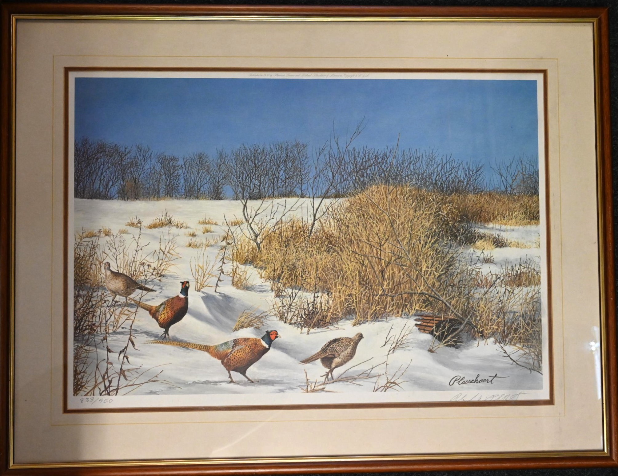 After Richard Plasschaert, Minnesota USA (b. 1941) signed print of Pheasants in snow landscape