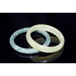 Two Chinese green hard stone bangles