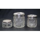 Three various sterling silver topped toiletry jars