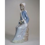 Lladro seated woman with Lily Bouquet