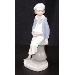 Lladro seated sailor boy with yacht figurine