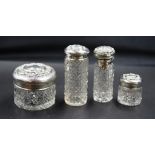 Cased set Edward VII silver topped crystal bottles