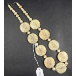 Bone necklace with Buddha image on disks