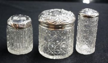 Three various sterling silver topped toiletry jars