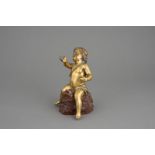 Goldputto: Feuervergoldeter Bronzeputto auf Felsgestein aus ädrigem...