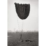 Capa, Robert: American paratrooper, lying on the ground next to his pa...