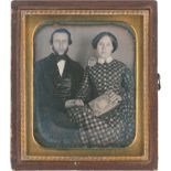 Daguerreotypes: Portrait of a young couple with a photo album