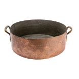A late 19th century copper preserve pan of plain circular form with brass loop carrying handles to