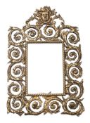 A pressed gilt brass wall mirror of arched outline,