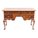 A burr walnut writing desk in George II style, elements 18th century and later,