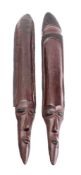A pair of African carved hardwood heads with elongated foreheads and geometric design decoration,