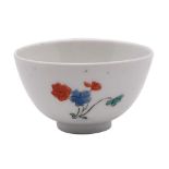 A small Japanese teabowl possibly Hizen ware, decorated in the kakiemon palette with floral sprays,