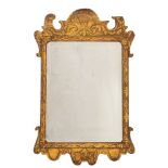 A George I giltwood and composition framed wall mirror,