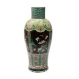 A large Chinese famille noire vase decorated with panels and bands of prunus,