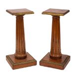 A pair of mahogany and gilt metal mounted columnar lamp stands in Louis XVI taste,