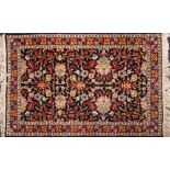 A Kashmiri rug:, the shaded field with an all over design of palmettes,