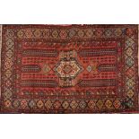 A Shiraz carpet, the shaded rose rectangular field with a central beige octagonal pole medallion,