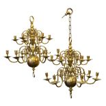 A pair of early 19th century brass fourteen branch chandaliers in the Dutch taste with two tiers of